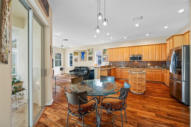 kitchen featuring ceiling fan, sink, tasteful backsplash, hardwood / wood-style floors, and appliances with stainless steel finishes