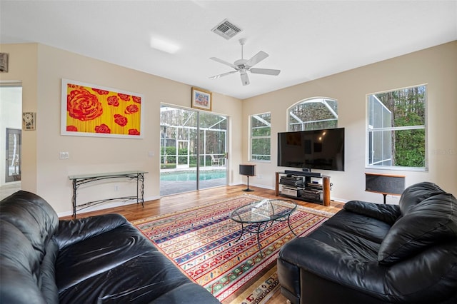 living room featuring ceiling fan and hardwood / wood-style floors