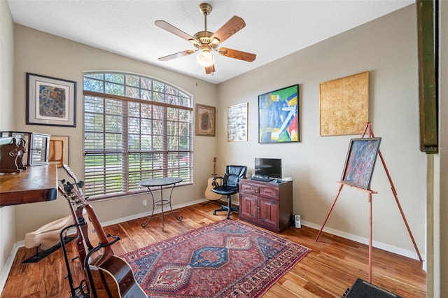 office area with ceiling fan and light hardwood / wood-style flooring