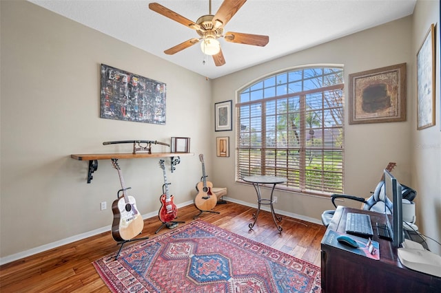 office space featuring hardwood / wood-style flooring, ceiling fan, and a healthy amount of sunlight