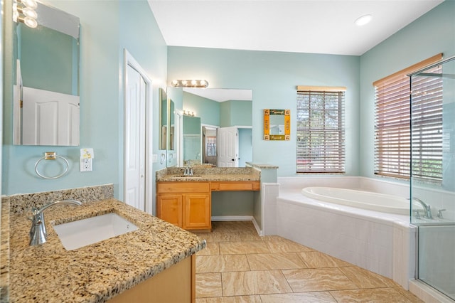 bathroom with vanity and independent shower and bath