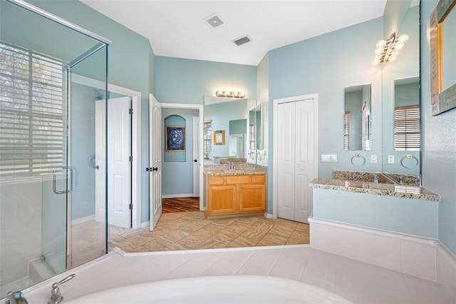 bathroom featuring hardwood / wood-style floors, vanity, and an enclosed shower