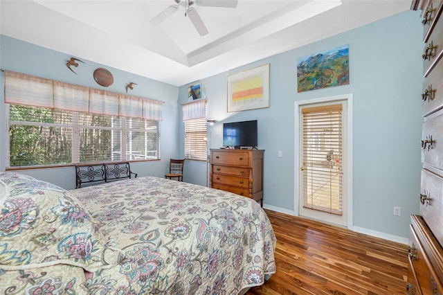 bedroom with access to exterior, hardwood / wood-style flooring, vaulted ceiling, and ceiling fan