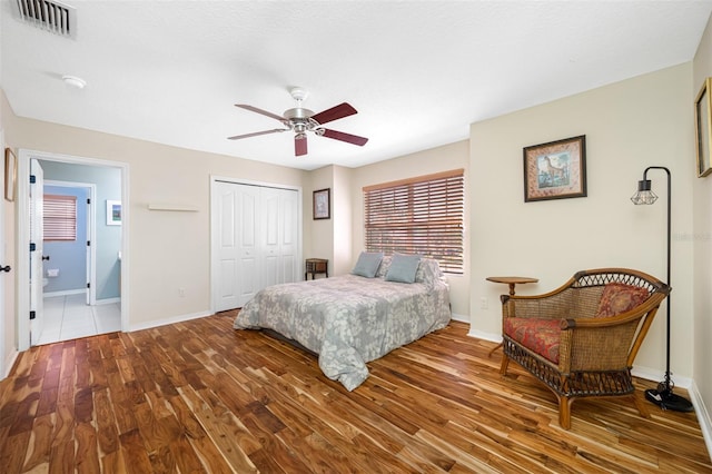 bedroom featuring wood-type flooring, a closet, and ceiling fan