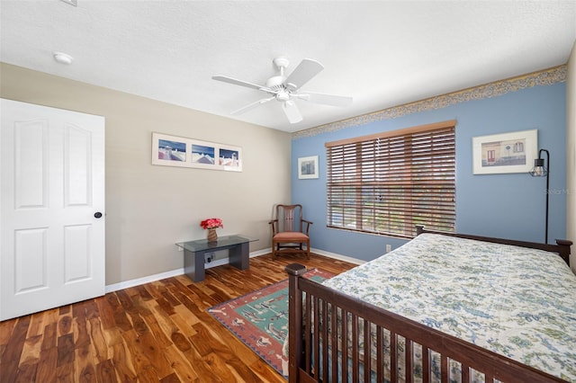 bedroom featuring a textured ceiling, dark hardwood / wood-style flooring, and ceiling fan