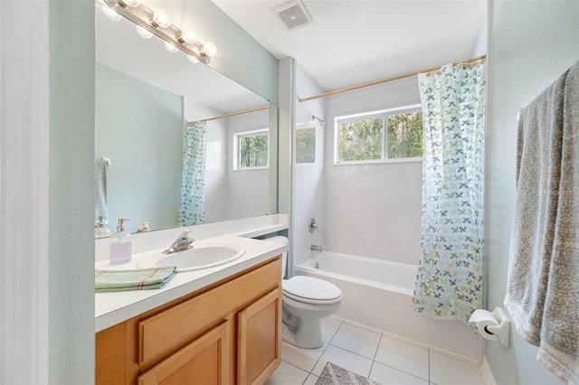 full bathroom featuring shower / bath combination with curtain, vanity, a textured ceiling, tile patterned flooring, and toilet