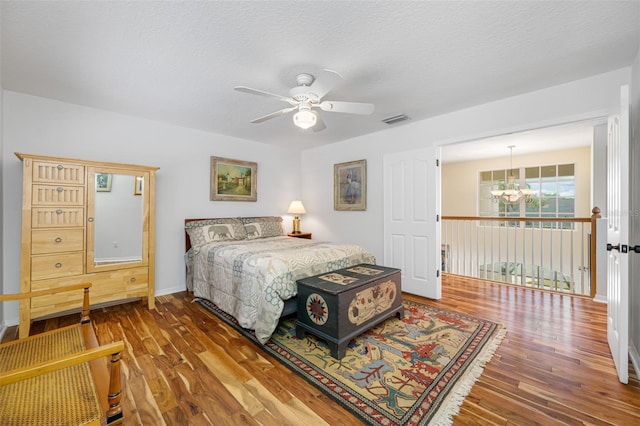 bedroom featuring ceiling fan, a textured ceiling, and hardwood / wood-style flooring