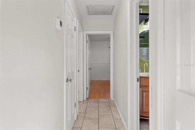 hall featuring light tile patterned floors