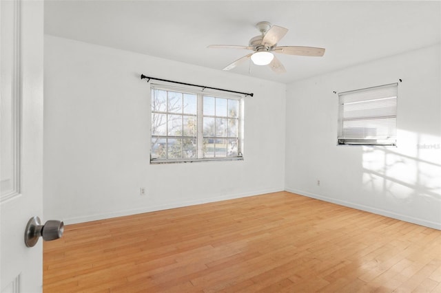 empty room featuring ceiling fan and light hardwood / wood-style flooring