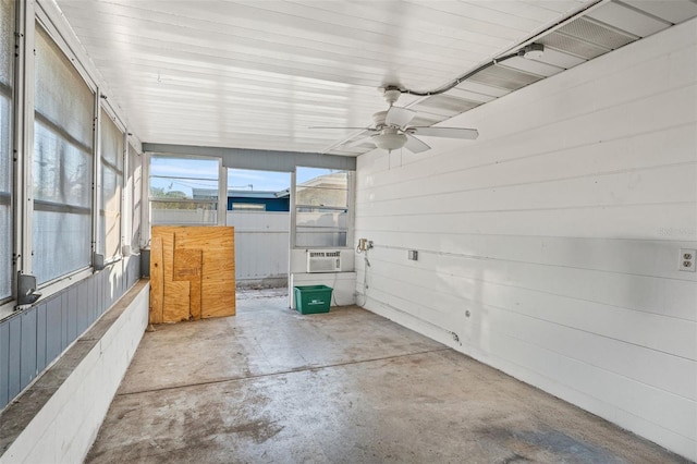 unfurnished sunroom with ceiling fan and cooling unit