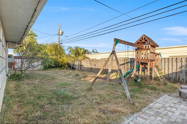 view of yard featuring a playground and a patio