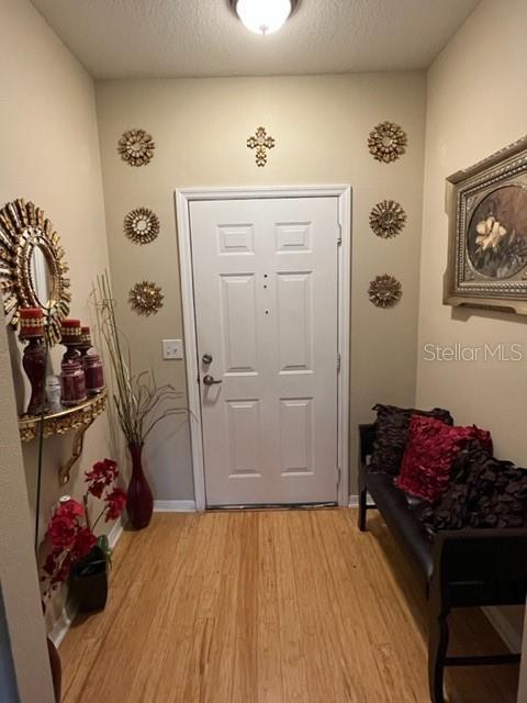 foyer featuring light hardwood / wood-style floors and a textured ceiling