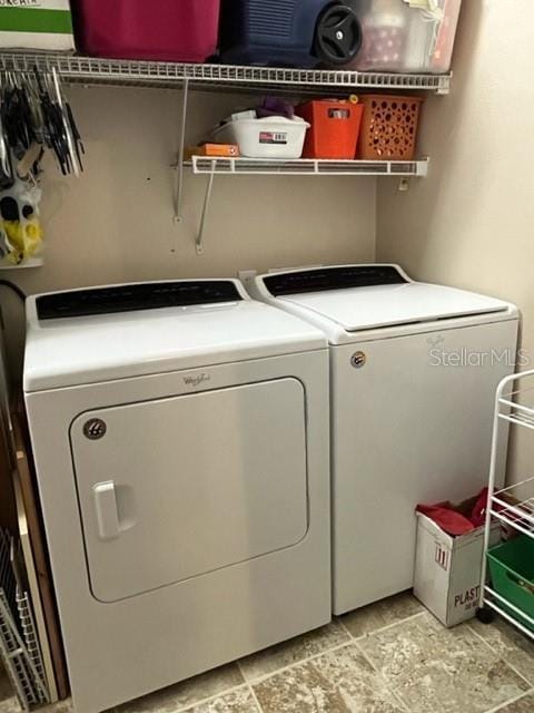 washroom featuring washer and clothes dryer