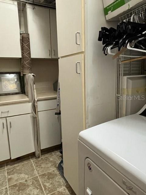 clothes washing area with washer / dryer