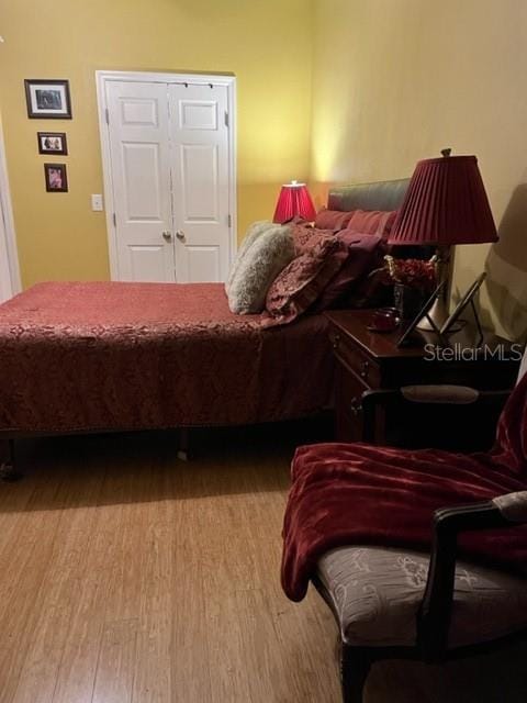 bedroom with light wood-type flooring and a closet