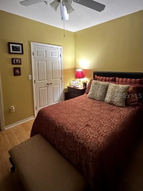 bedroom with ceiling fan and wood-type flooring