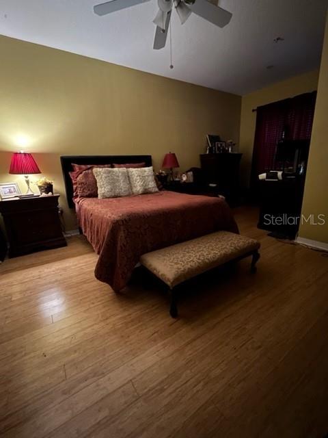 bedroom with ceiling fan and light wood-type flooring