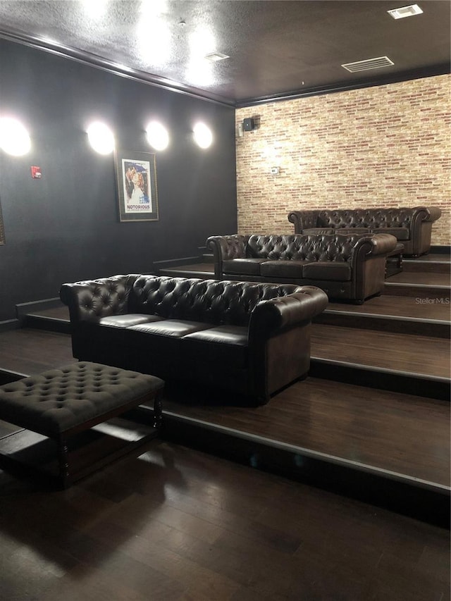 home theater room with crown molding and hardwood / wood-style floors