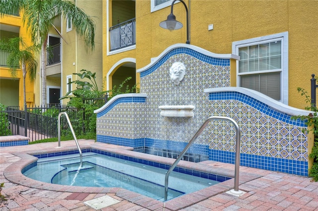 view of pool featuring a hot tub