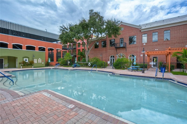 view of pool with a pergola and a patio