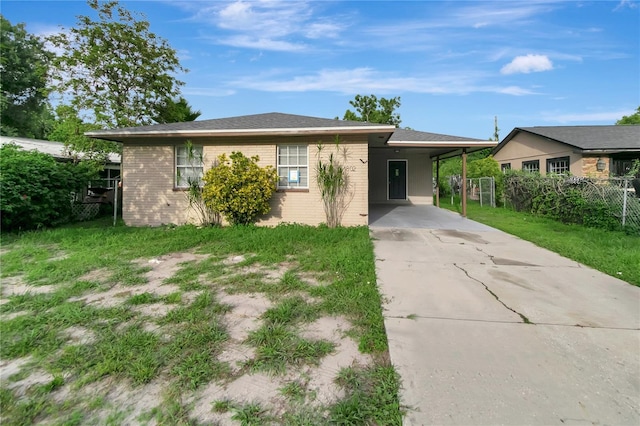 ranch-style house with a front lawn and a carport