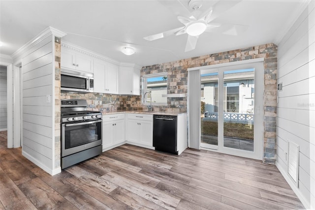 kitchen with white cabinets, dark hardwood / wood-style floors, sink, and appliances with stainless steel finishes