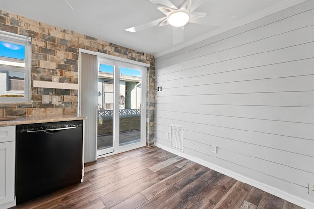 interior space with wood walls, dark hardwood / wood-style floors, and ceiling fan