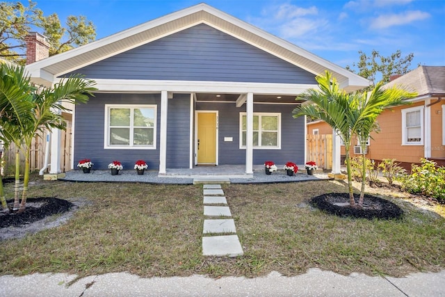 bungalow-style home featuring a porch and a front yard