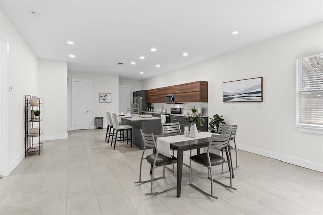 tiled dining area featuring sink