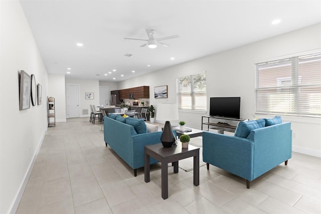 tiled living room featuring ceiling fan