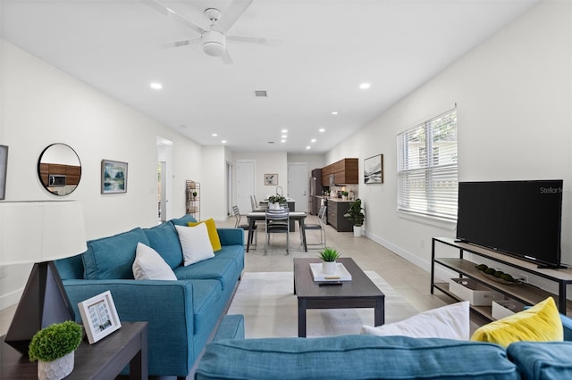 living room with light tile patterned floors and ceiling fan