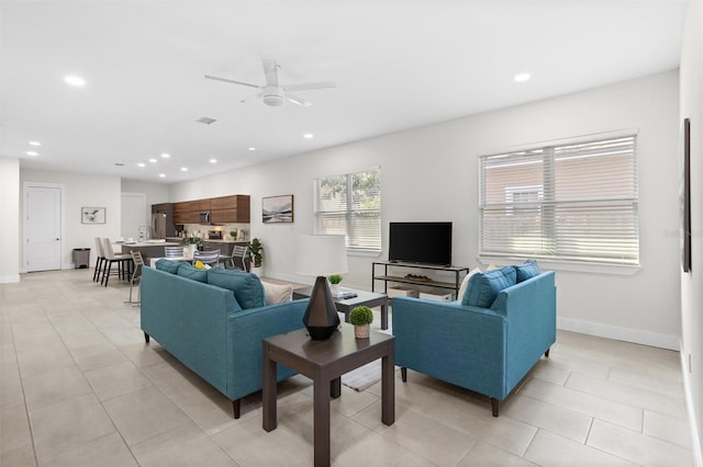 tiled living room featuring ceiling fan