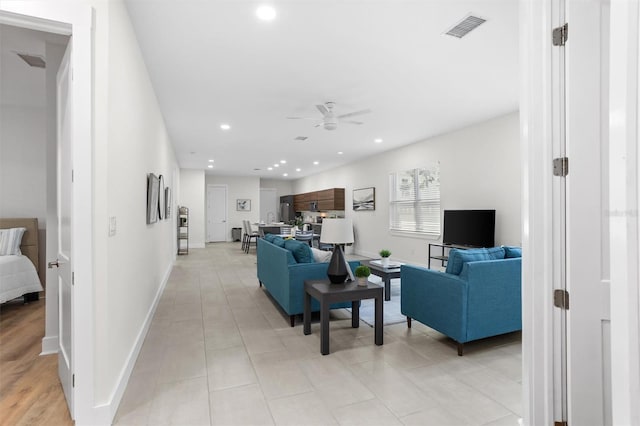 living room featuring ceiling fan and light tile patterned flooring