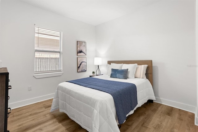 bedroom with hardwood / wood-style floors