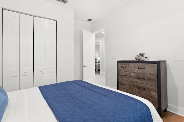 bedroom featuring hardwood / wood-style floors and a closet