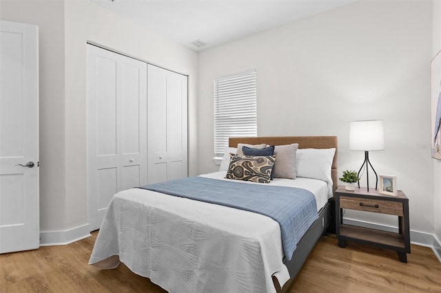 bedroom with hardwood / wood-style flooring and a closet