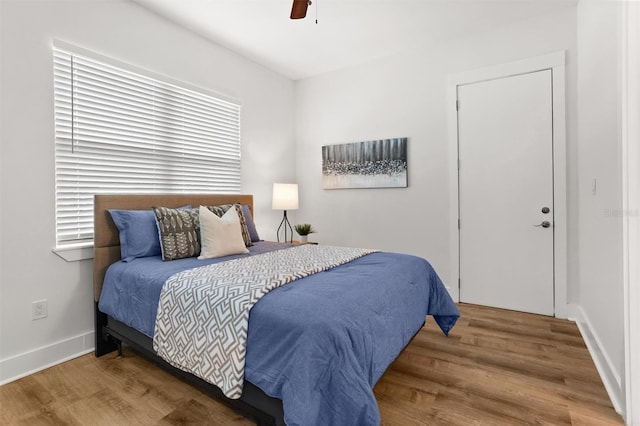 bedroom featuring hardwood / wood-style floors and ceiling fan