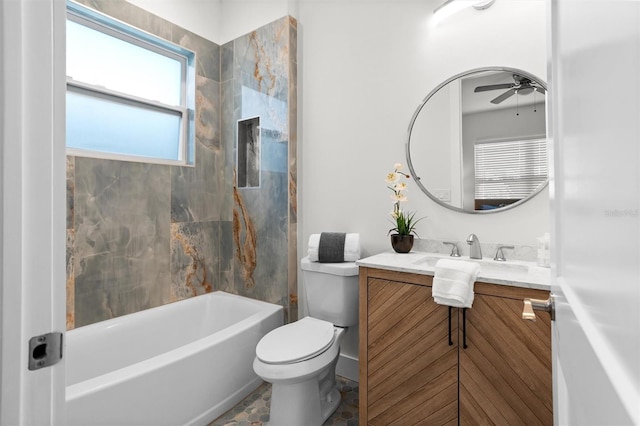 full bathroom with ceiling fan, toilet, tiled shower / bath, and vanity