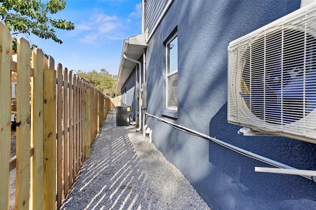 view of side of home with central air condition unit