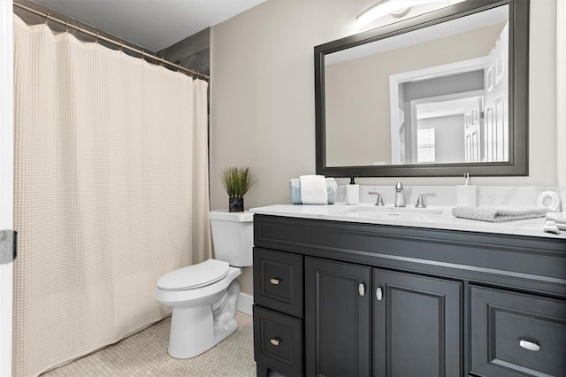 bathroom featuring tile patterned flooring, vanity, and toilet