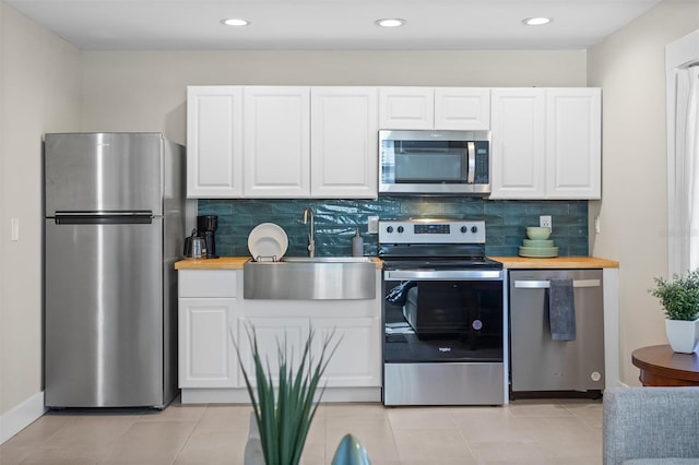 kitchen featuring sink, white cabinetry, and stainless steel appliances