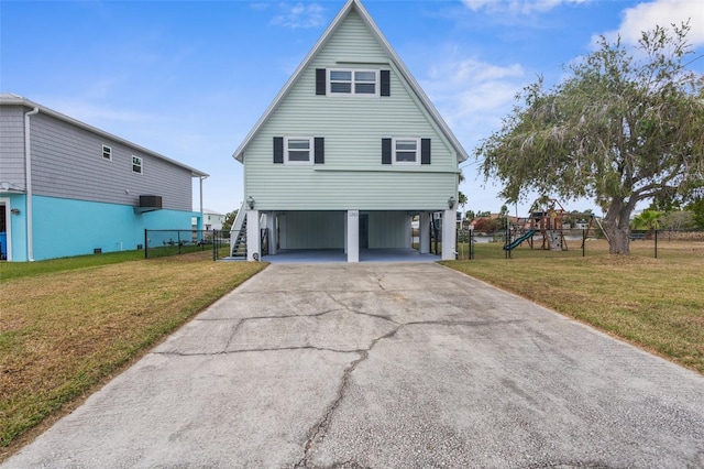 exterior space with a carport, a playground, and a front lawn