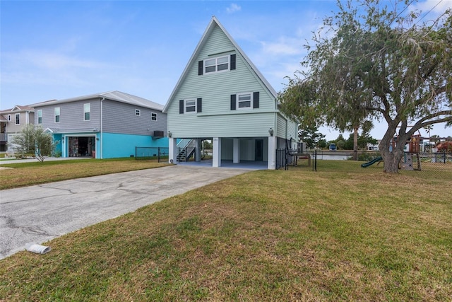 back of property featuring a lawn and a carport