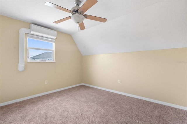 additional living space with a wall mounted air conditioner, ceiling fan, carpet floors, and vaulted ceiling