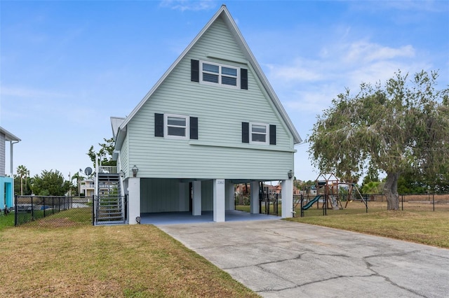 exterior space with a carport, stairway, driveway, a front lawn, and a playground