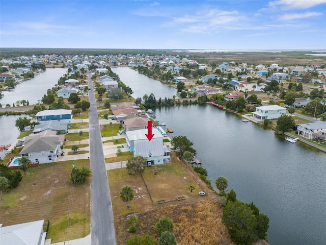 bird's eye view featuring a water view and a residential view