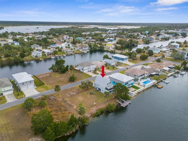 drone / aerial view with a water view and a residential view