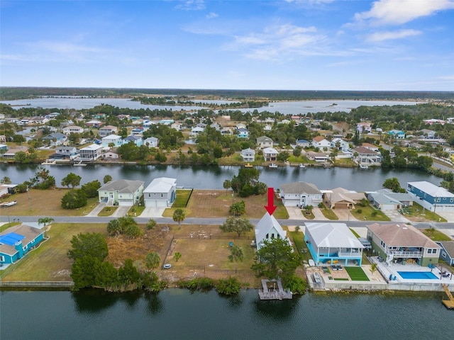 birds eye view of property featuring a water view and a residential view