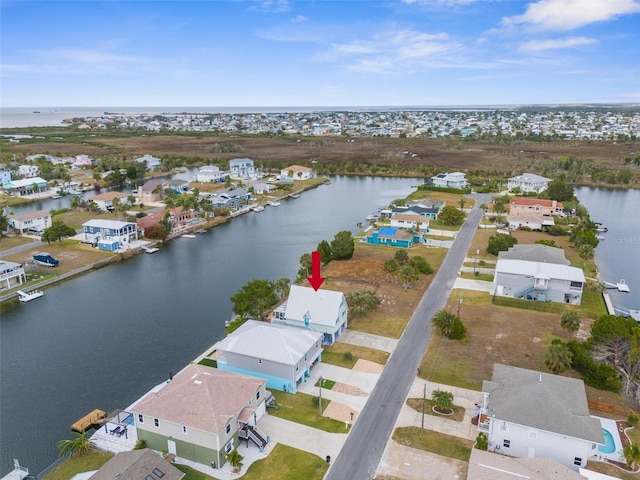 birds eye view of property with a water view and a residential view