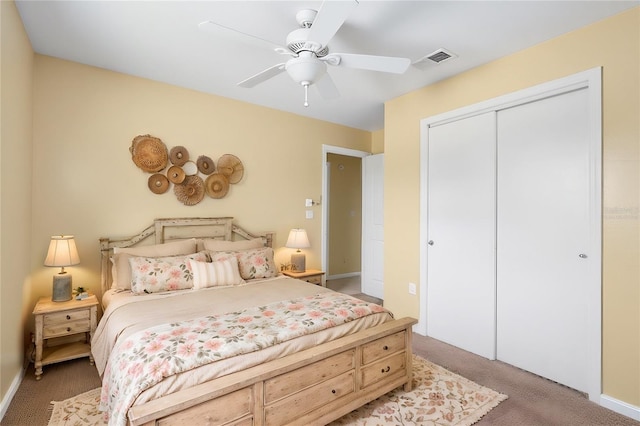 bedroom with carpet flooring, visible vents, a closet, and ceiling fan